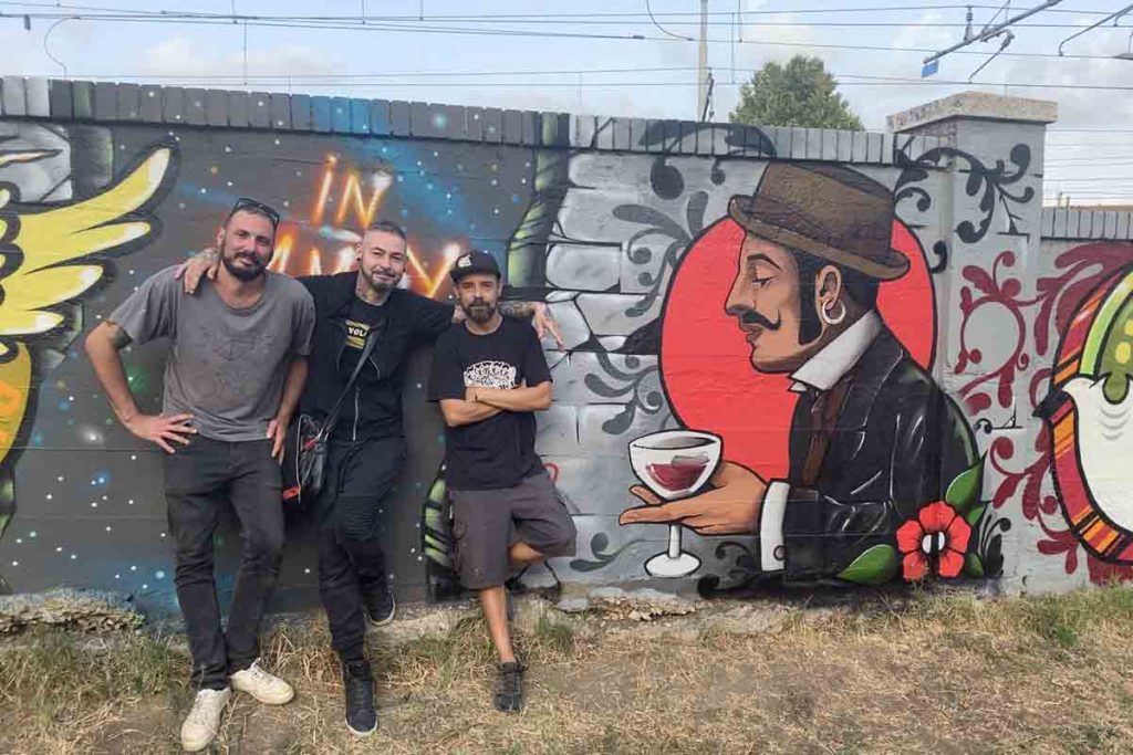 Tre dei ragazzi che hanno realizzato il murale davanti a "In the memory of"