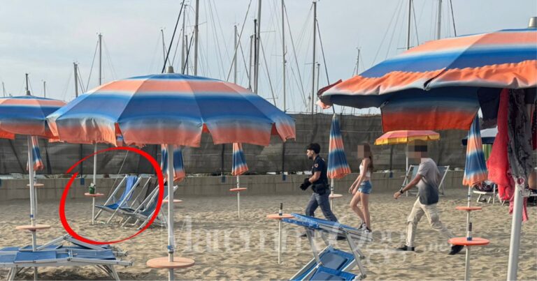 Il sopralluogo della polizia all'ombrellone occupato dai due, nel cerchio si vedono alcune bottiglie di birra e alcolici