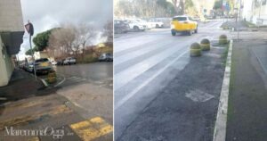 Un auto in sosta sull'isola di traffico in via Monte Rosa e i dissuasori di velocitÃ